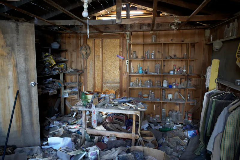A cluttered garage shed packed with old household items before a cleanout in Bangor